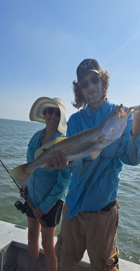 Speckled trout catch displayed on fishing boat on open water