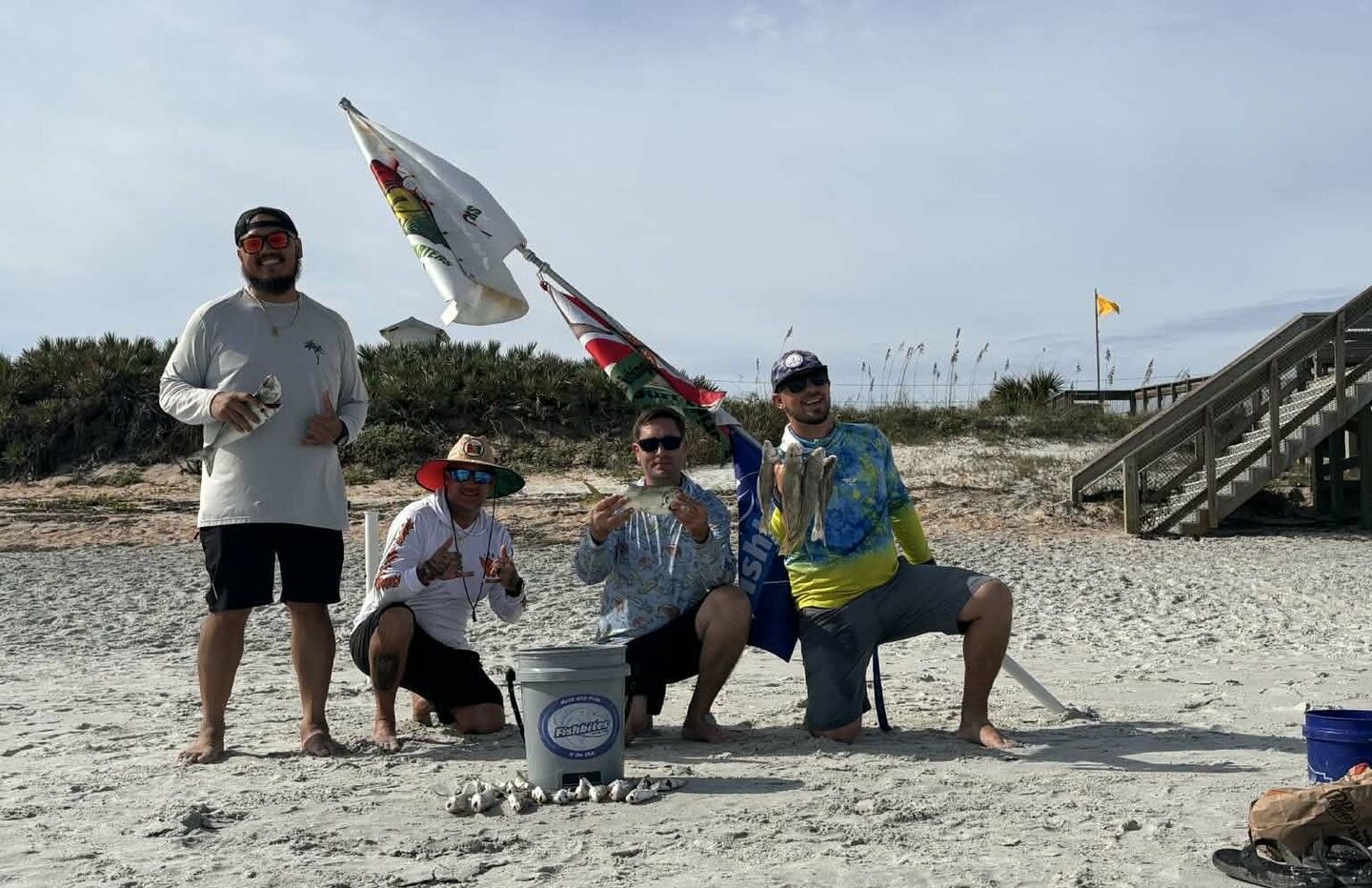 Four people enjoying a successful fishing trip