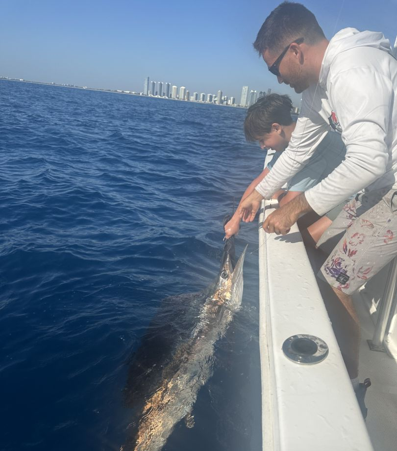Two people enjoying a fishing trip at an unknown location