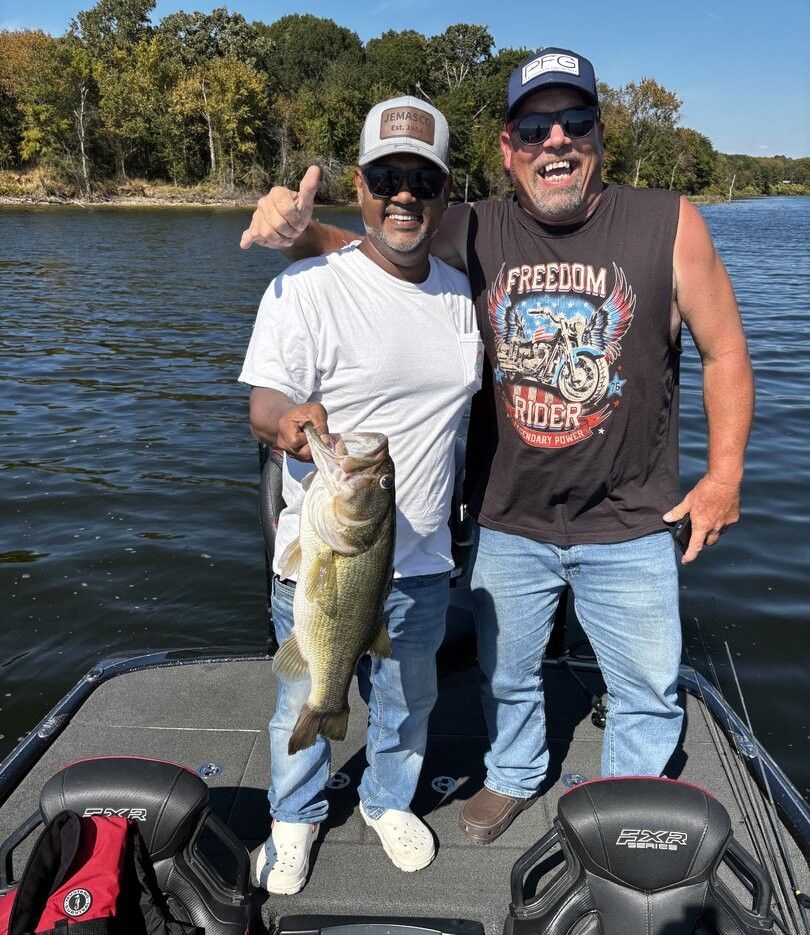 Two people fishing in unknown location