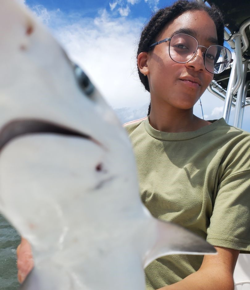 A fisherman casting a line in an unknown location