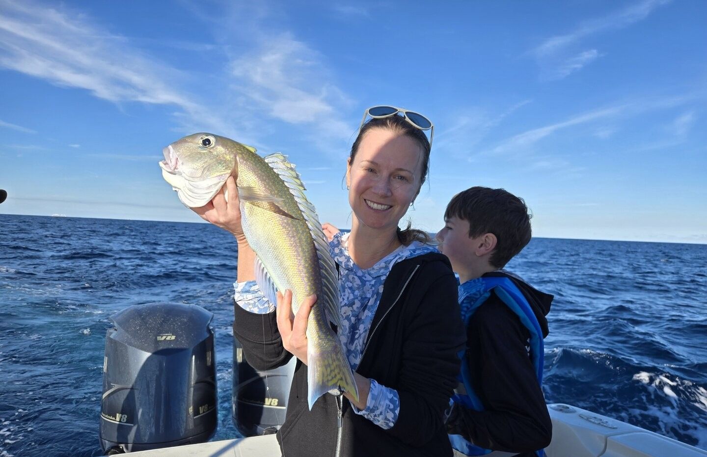 Fresh caught fish displayed on fishing boat in open ocean waters