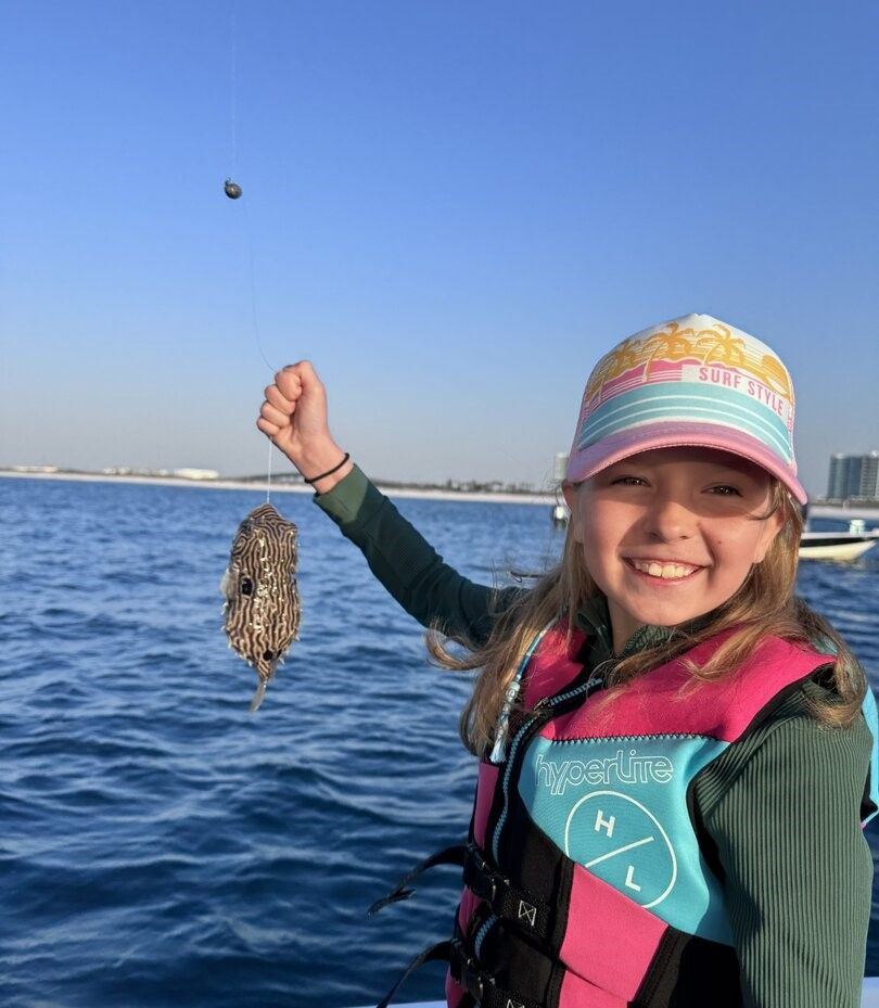 Freshly caught flatfish displayed after successful fishing trip on blue water