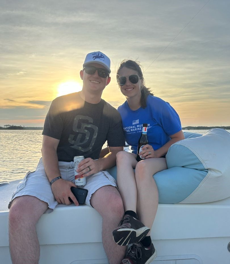 Sunset boating scene with people relaxing on boat deck over calm water