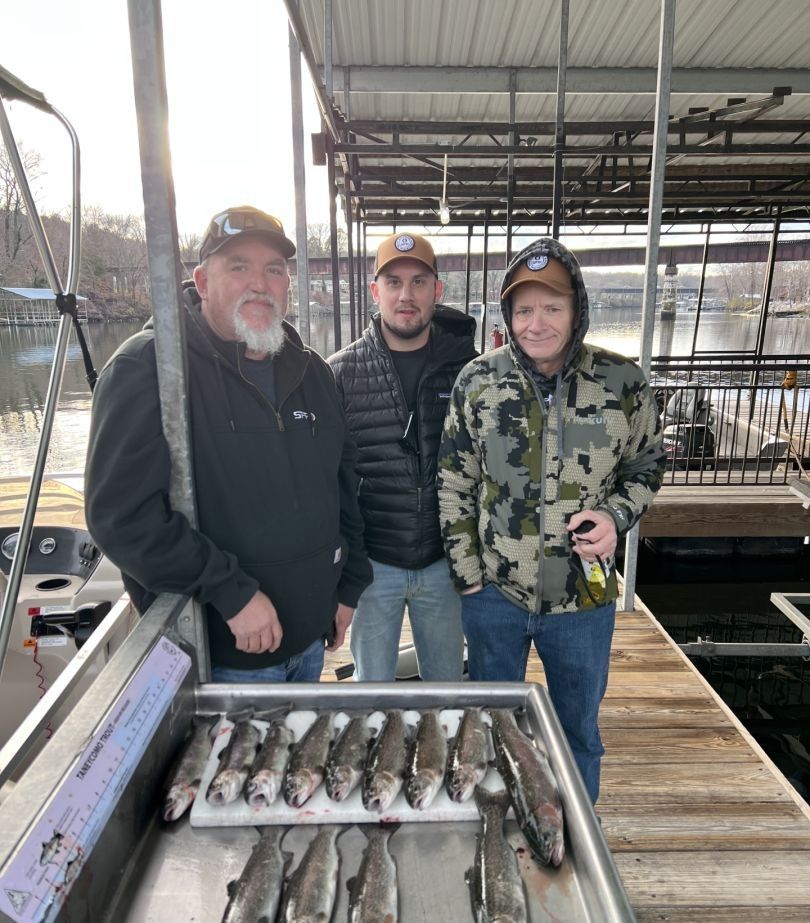 Three people fishing in a scenic location