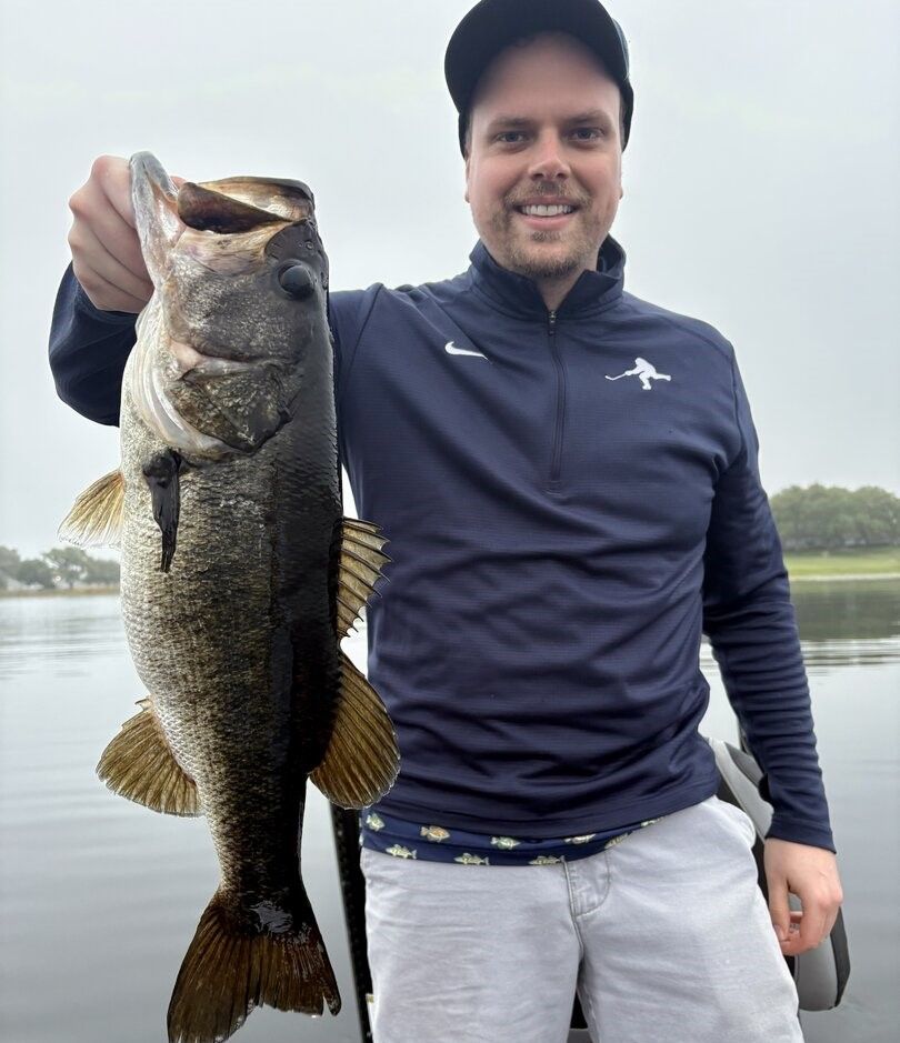 Large bass fish caught while fishing on lake