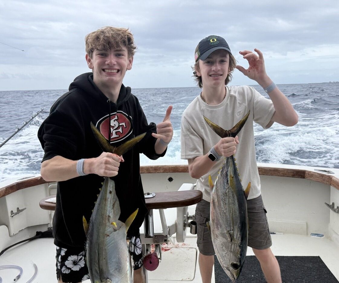 Two yellowfin tuna caught during offshore fishing trip on boat deck
