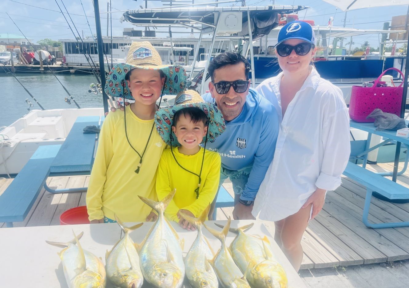 Fresh caught yellowtail fish displayed on fishing boat deck at marina