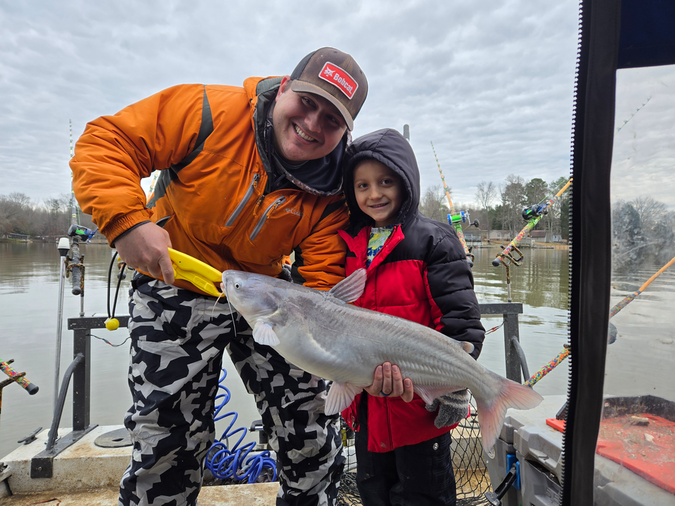 "Anglers braving the elements for a day of winter fishing at the lakeside platform."
