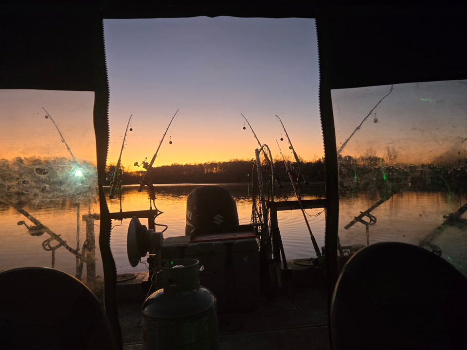 "Peaceful Dusk on the Lake: A Tranquil Fishing Expedition at Sunset."