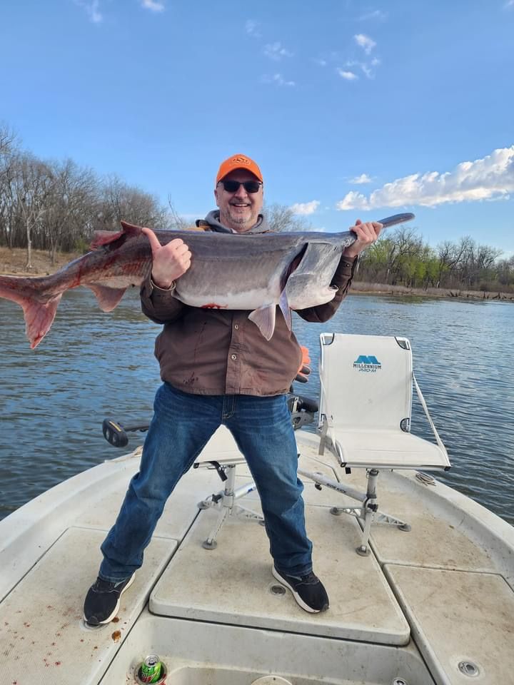 A person fishing in an unknown location