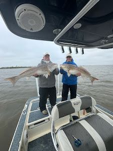 Two anglers with a great fishing catch