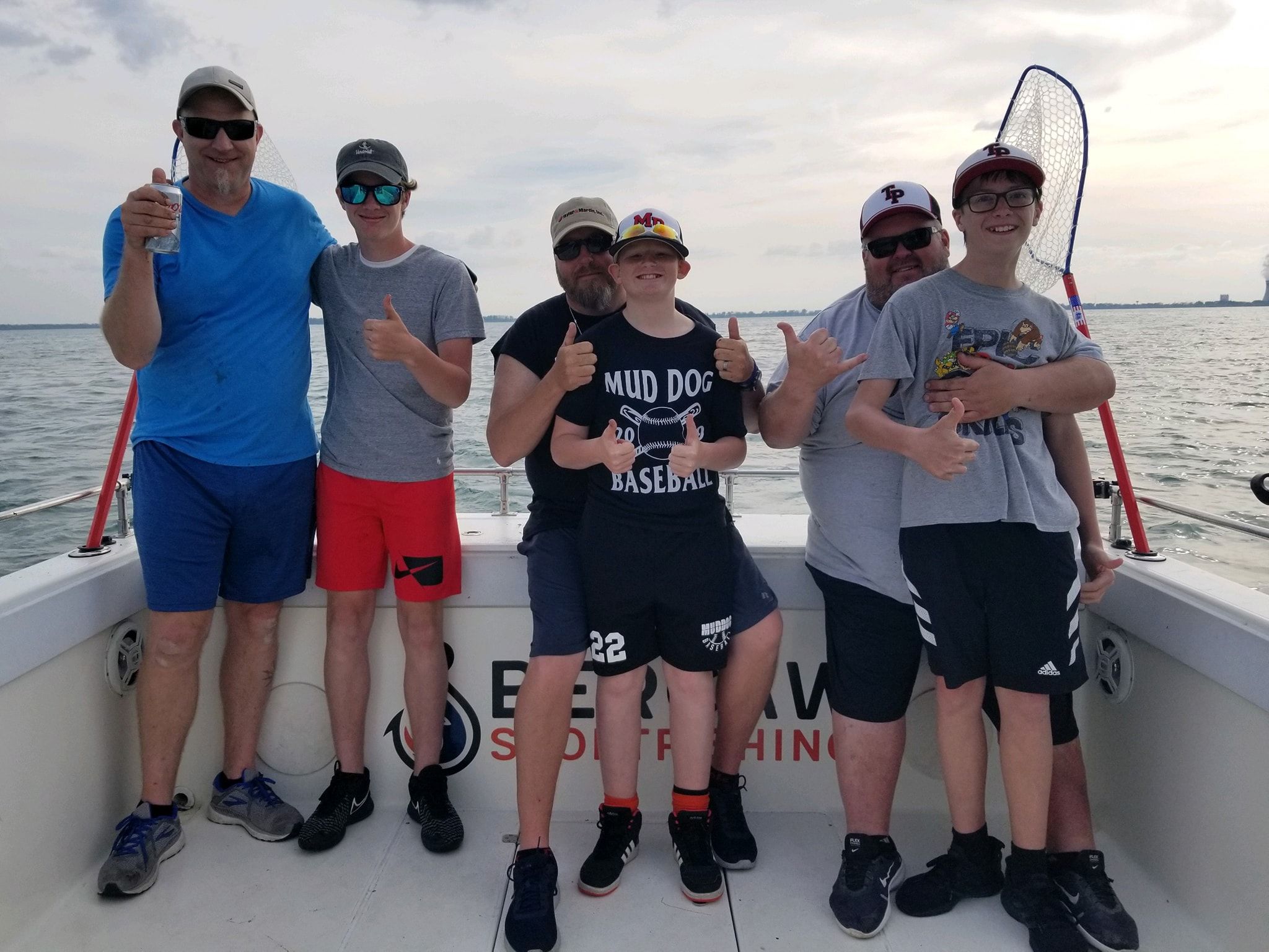 Group of 6 people fishing in an unknown location