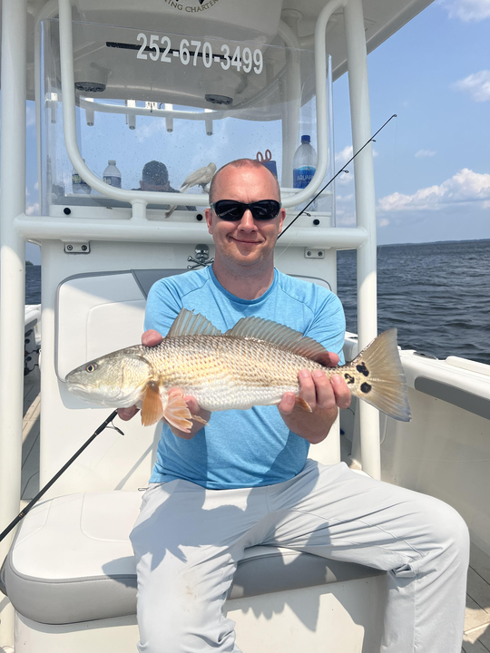 A mighty redfish hooked on the Light Tackle under partly cloudy skies with late afternoon rain!