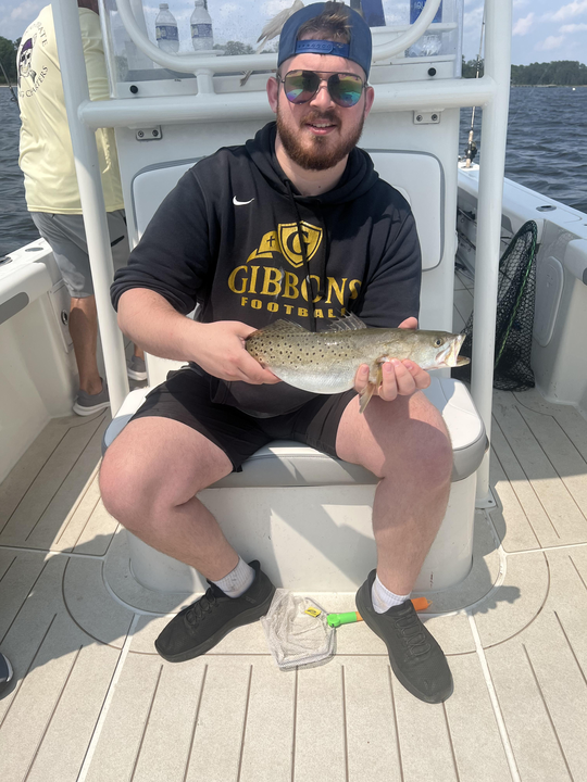 Landed a feisty spotted weakfish with light tackle under a partly cloudy sky.