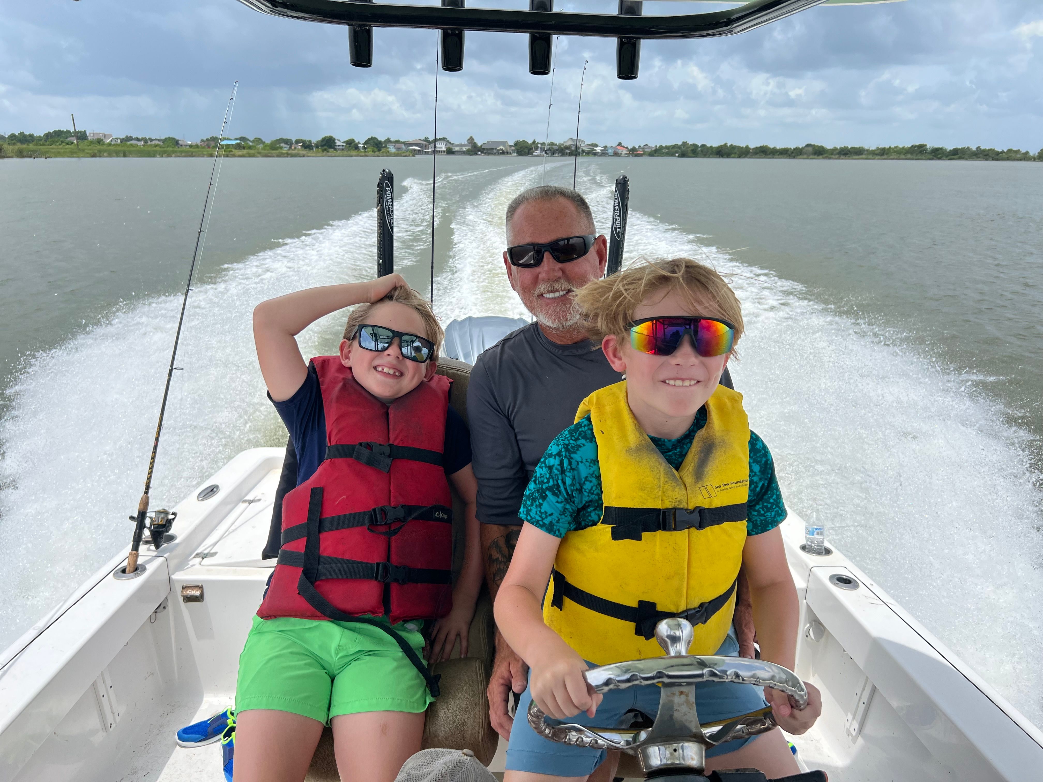 Boat on water with wake trailing behind during boating trip