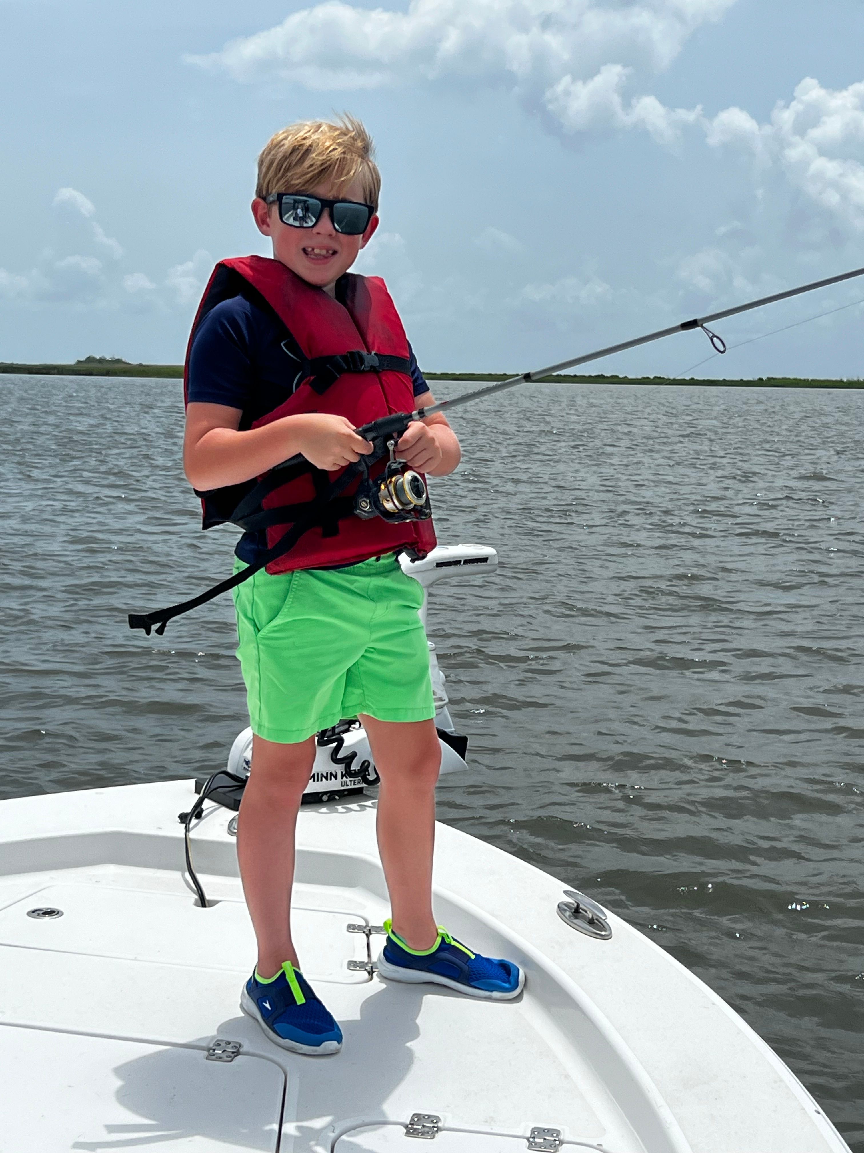Fishing rod held on boat deck over open water