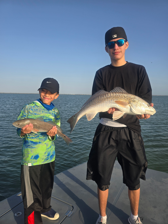 Reeling in a big one by the lake.