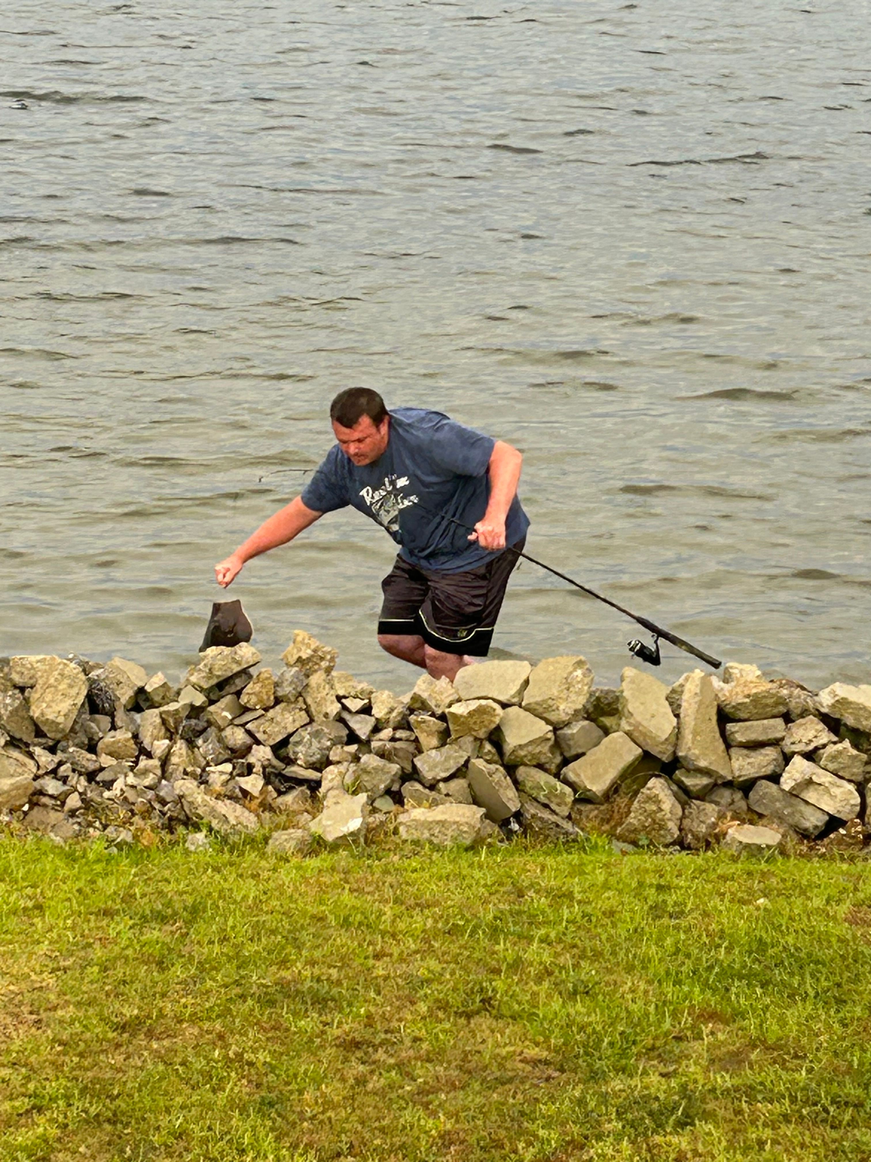 A person fishing at an unknown location
