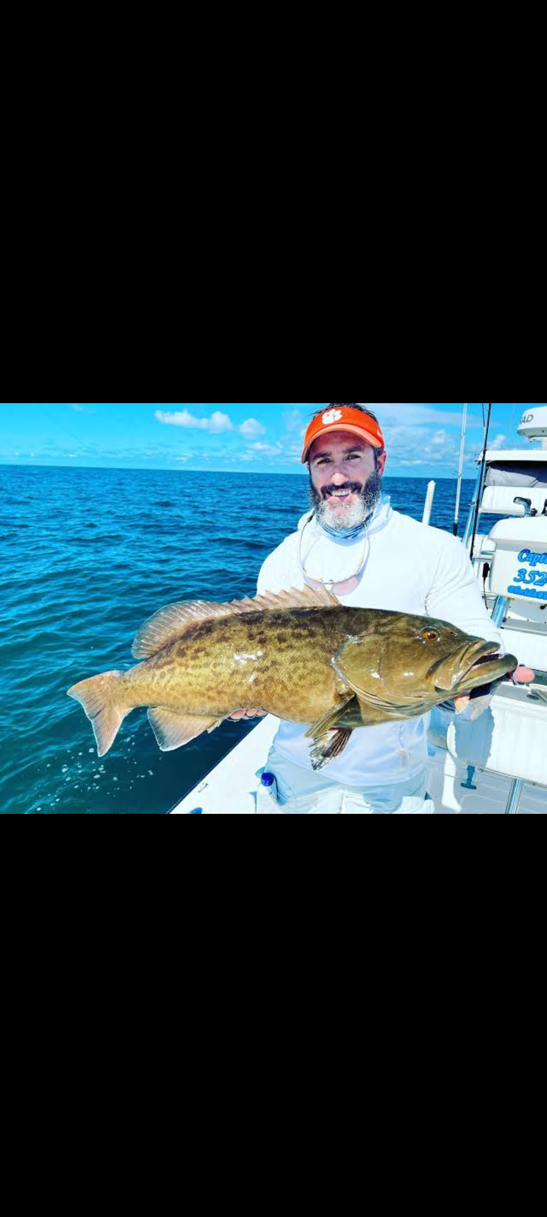Angler with big fish in unknown location