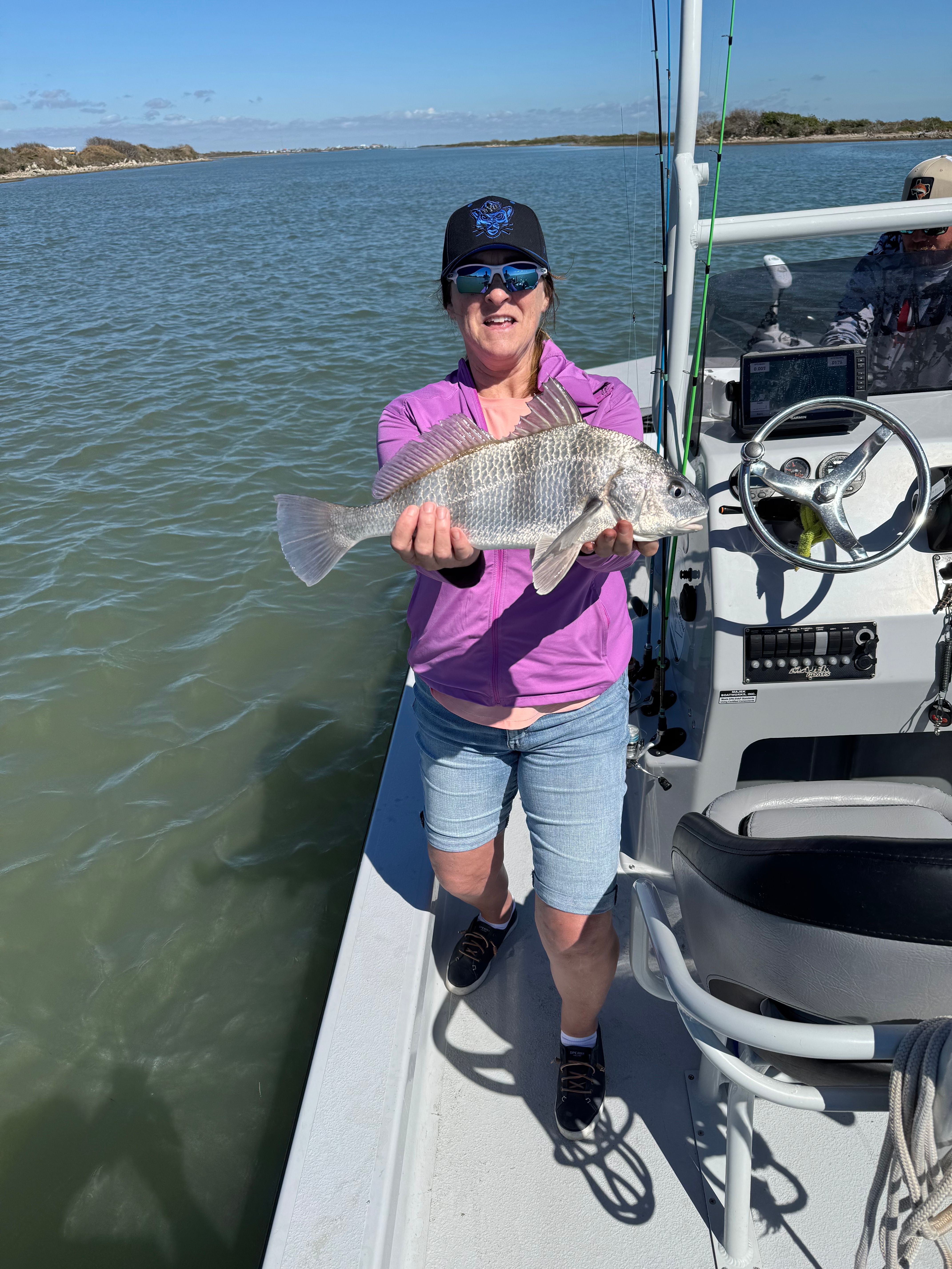 Angler catching a black drum fish