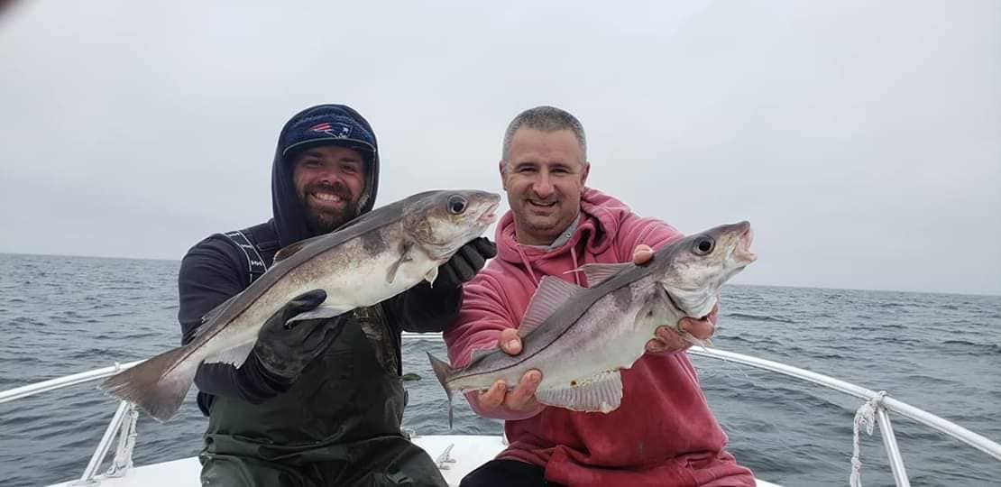 Two anglers fishing at an unknown location