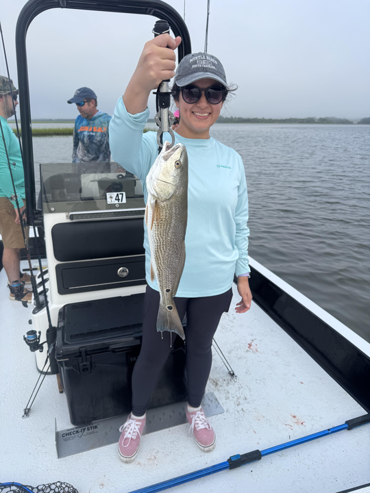Light tackle magic: Reeling in a redfish as the clouds part!