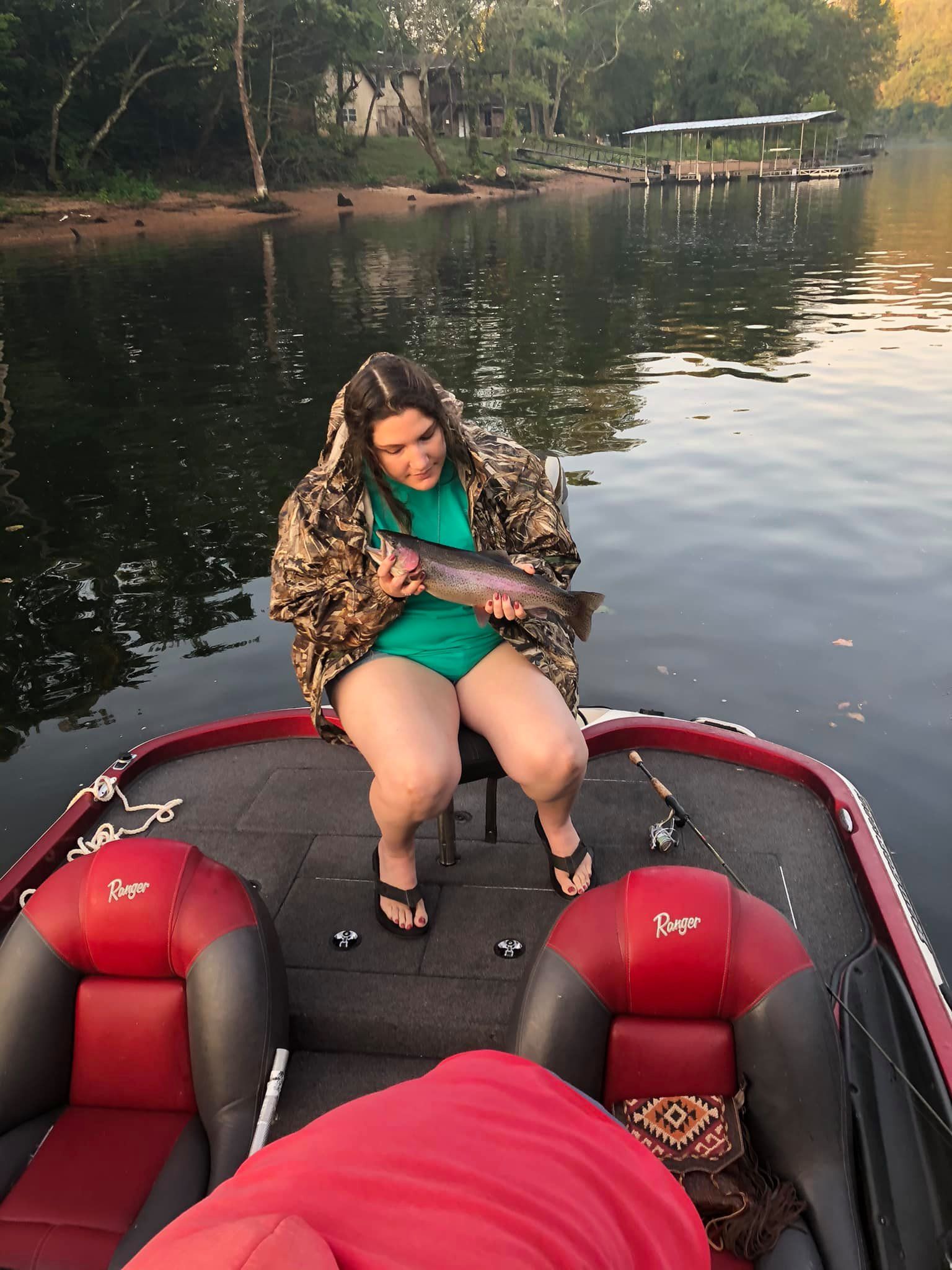 Angler catching a rainbow trout