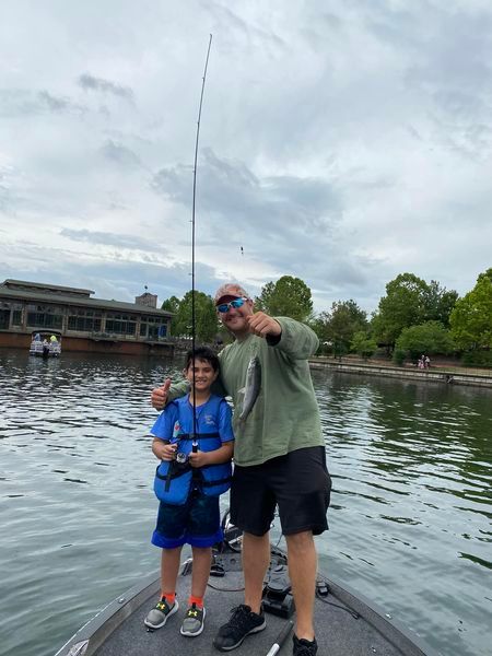 Two anglers enjoying a fishing trip at an unknown location.