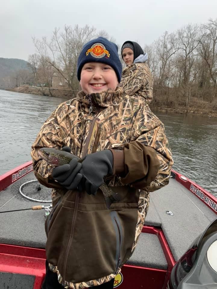 Two people fishing at an unknown location