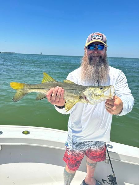 Angler with a 22-inch fish during an unknown fishing trip