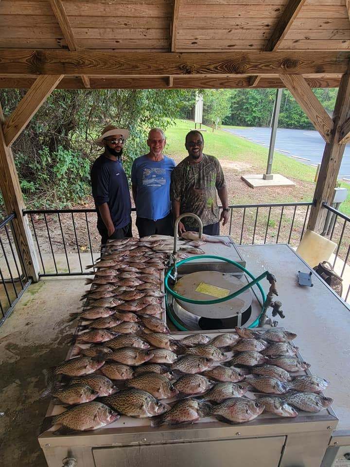 Three people fishing on the water