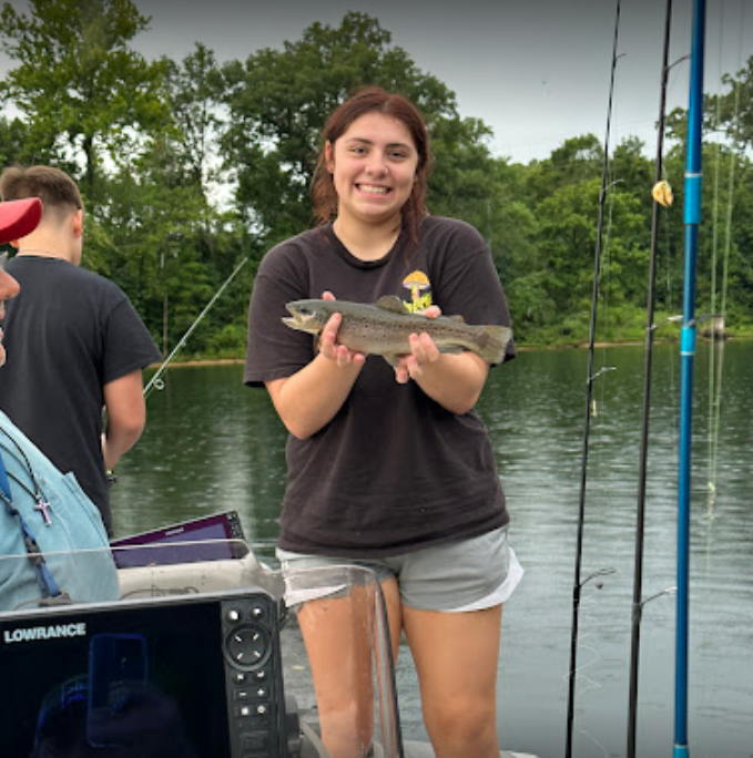 Angler with a rainbow trout fish catch