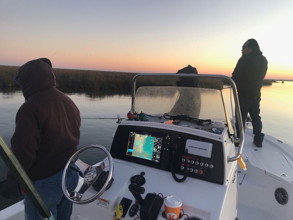 A person fishing in an unknown location