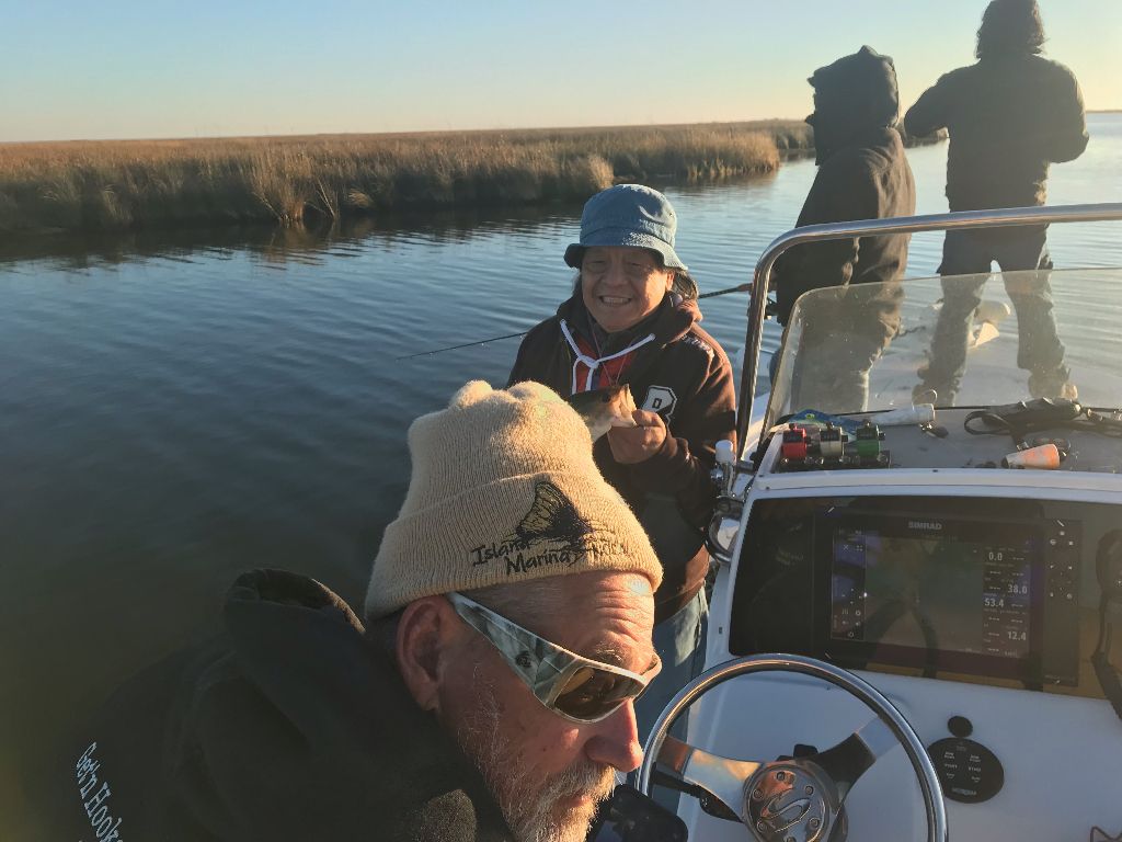 Two people fishing at an unknown location