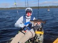 Angler fishing with rod and reel in unknown location