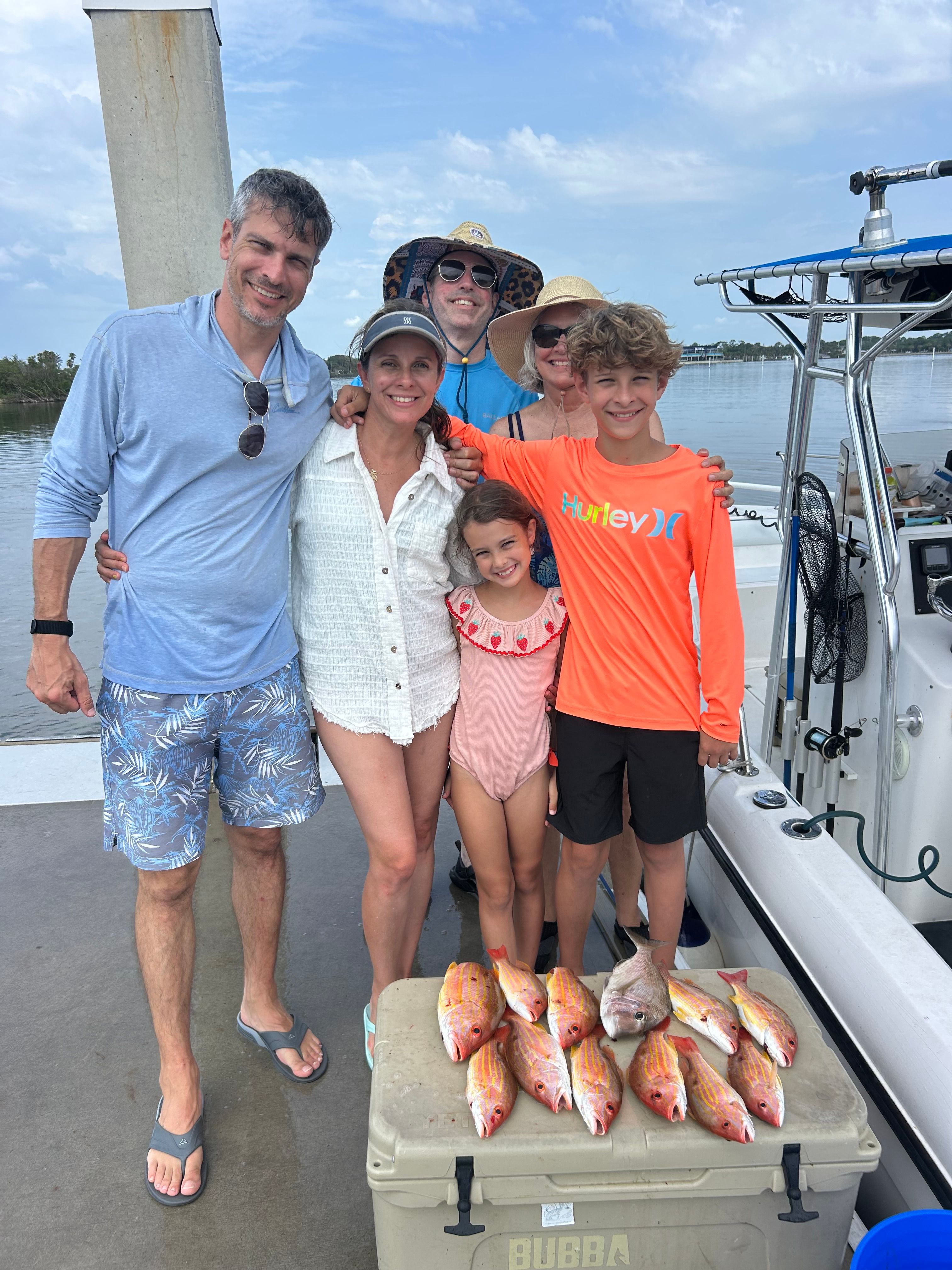 Fresh caught red snapper displayed on fishing boat deck after successful fishing trip