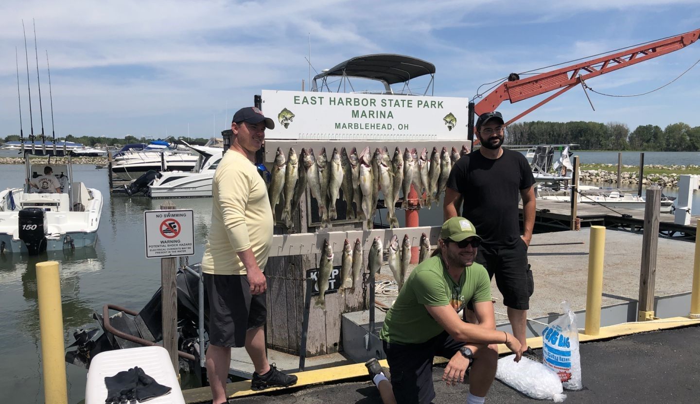 Three people fishing at a scenic location