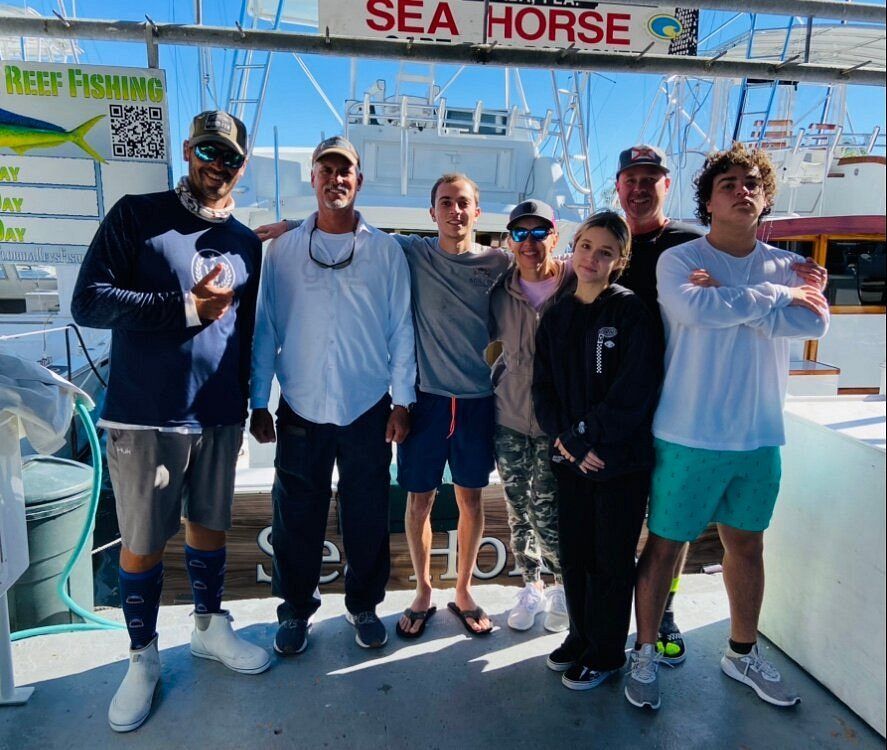 Group of 7 people fishing in a scenic location