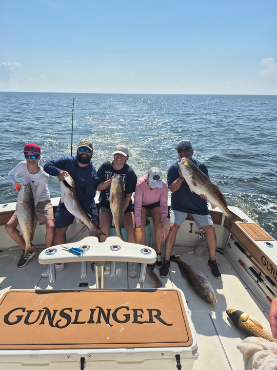 Reeling in a monster haul of redfish on a partly cloudy day in Biloxi!