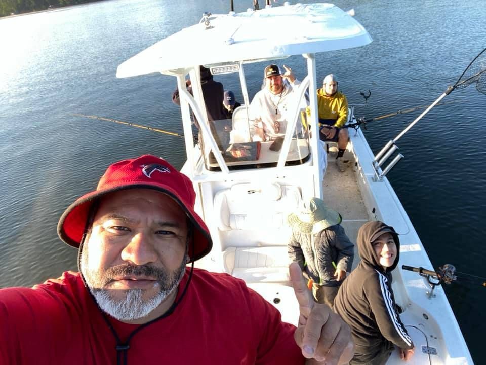 Four anglers enjoying a successful fishing trip
