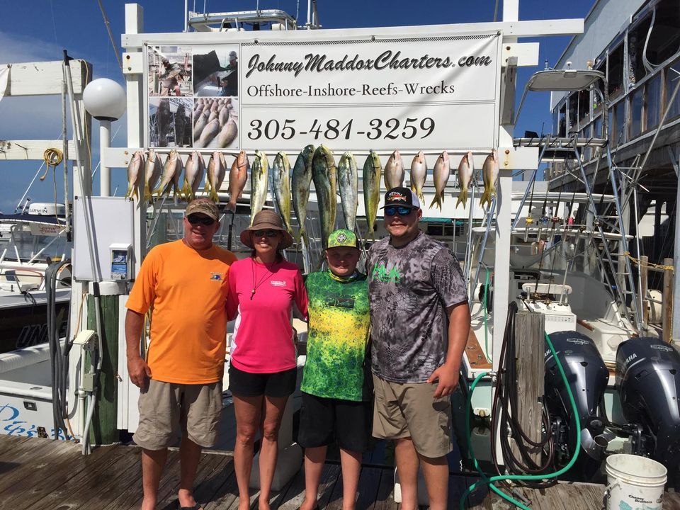 Four people fishing in an unknown location