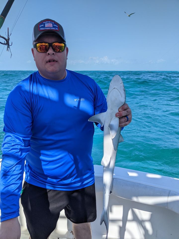 A person fishing in an unknown location.