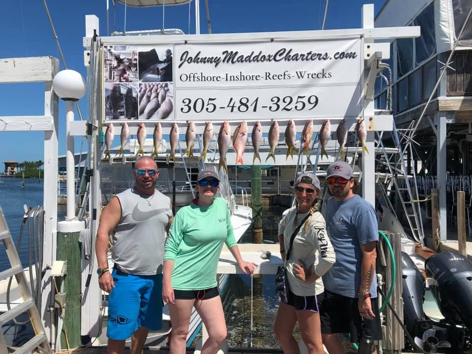 Four anglers fishing in a scenic location