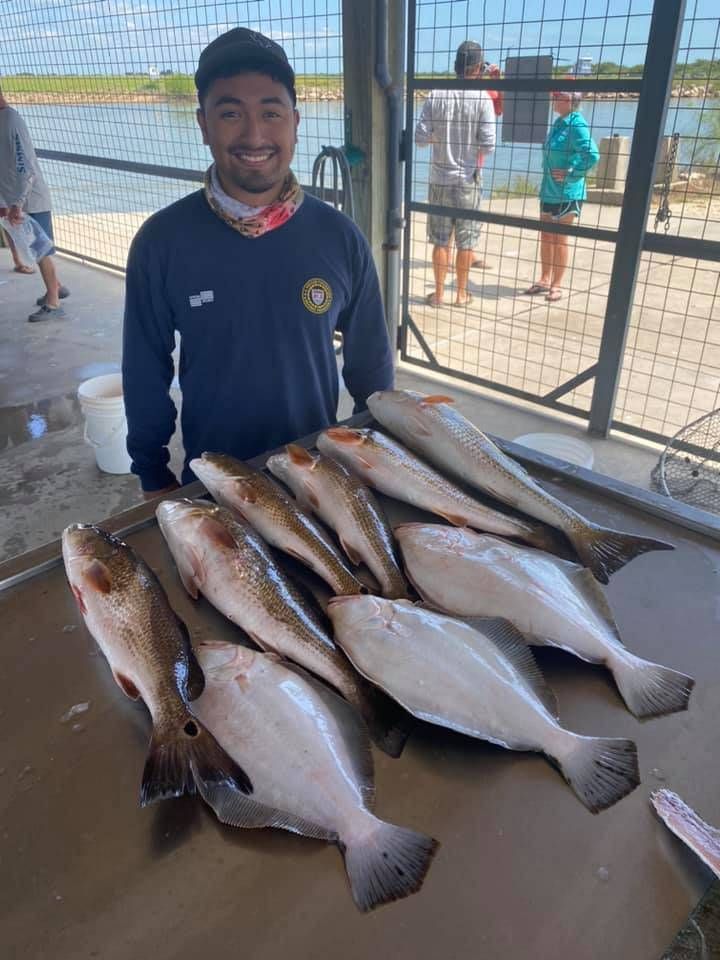 A fisherman with 5 caught fish on an unknown location