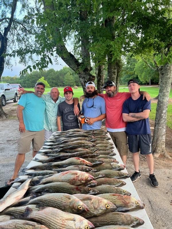 Anglers with big fish on fishing trip