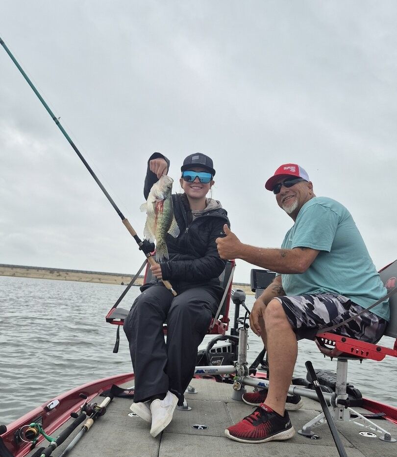 Bass fishing on a lake with caught fish being displayed