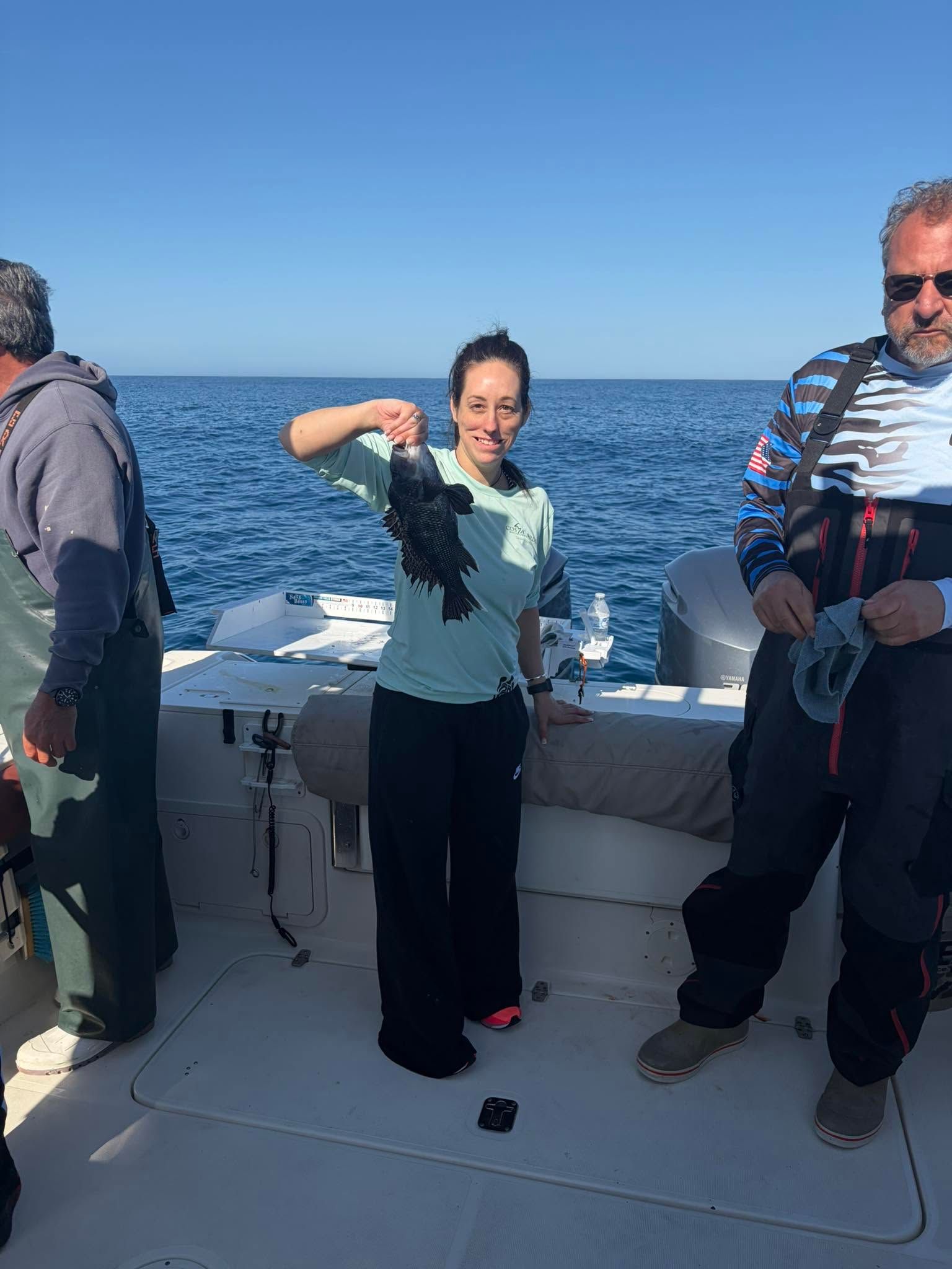 Black sea bass caught during fishing trip on boat in ocean