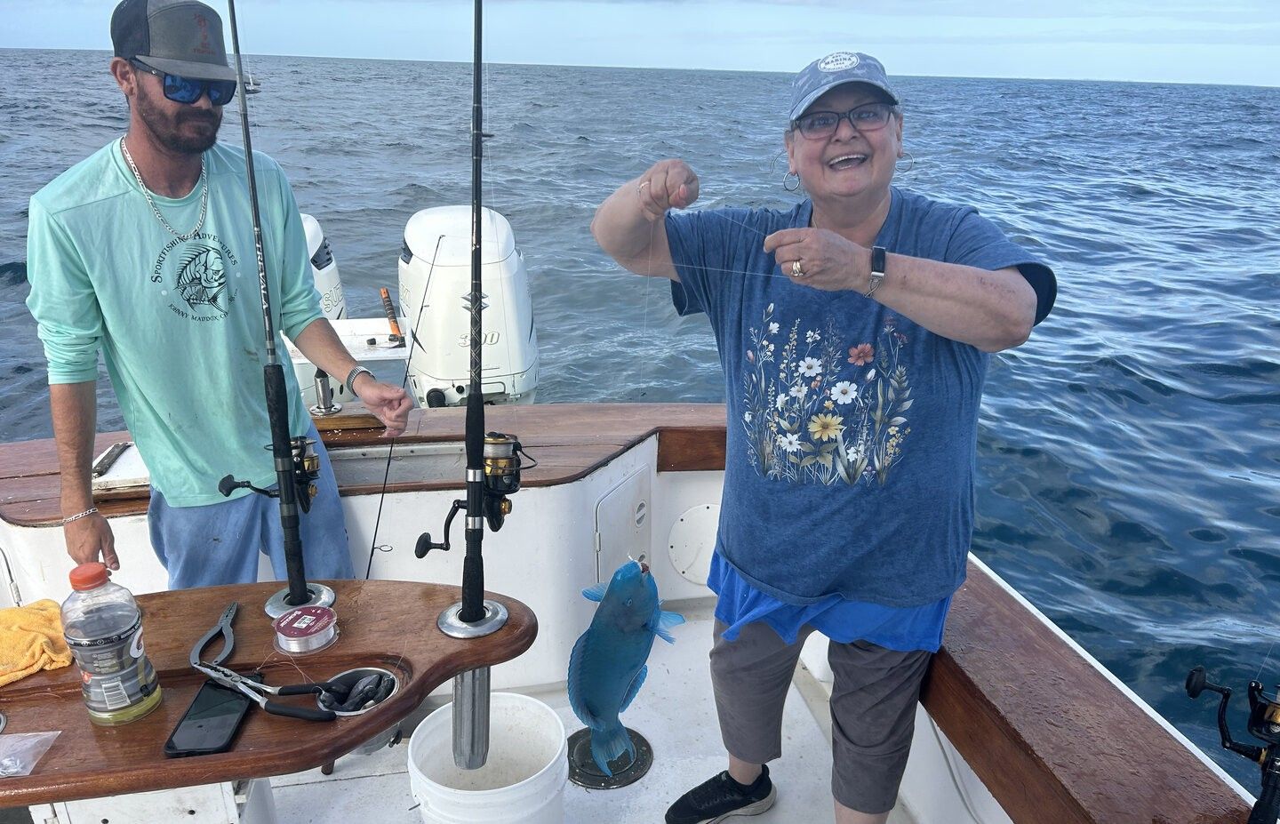 Deep sea fishing catch with blue parrotfish on boat deck