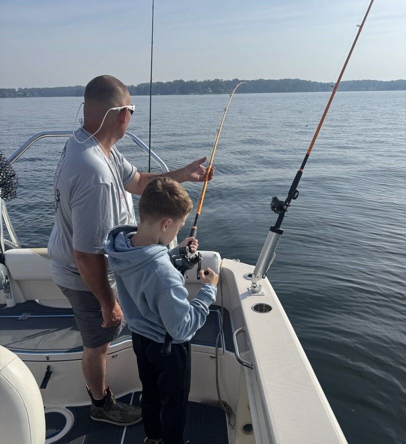 Fishing from boat on calm water with fishing rods and equipment
